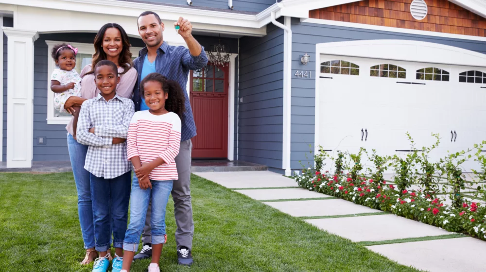 Family standing in front of new home.