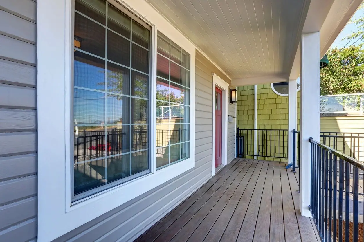 Front porch with wood deck and railing.